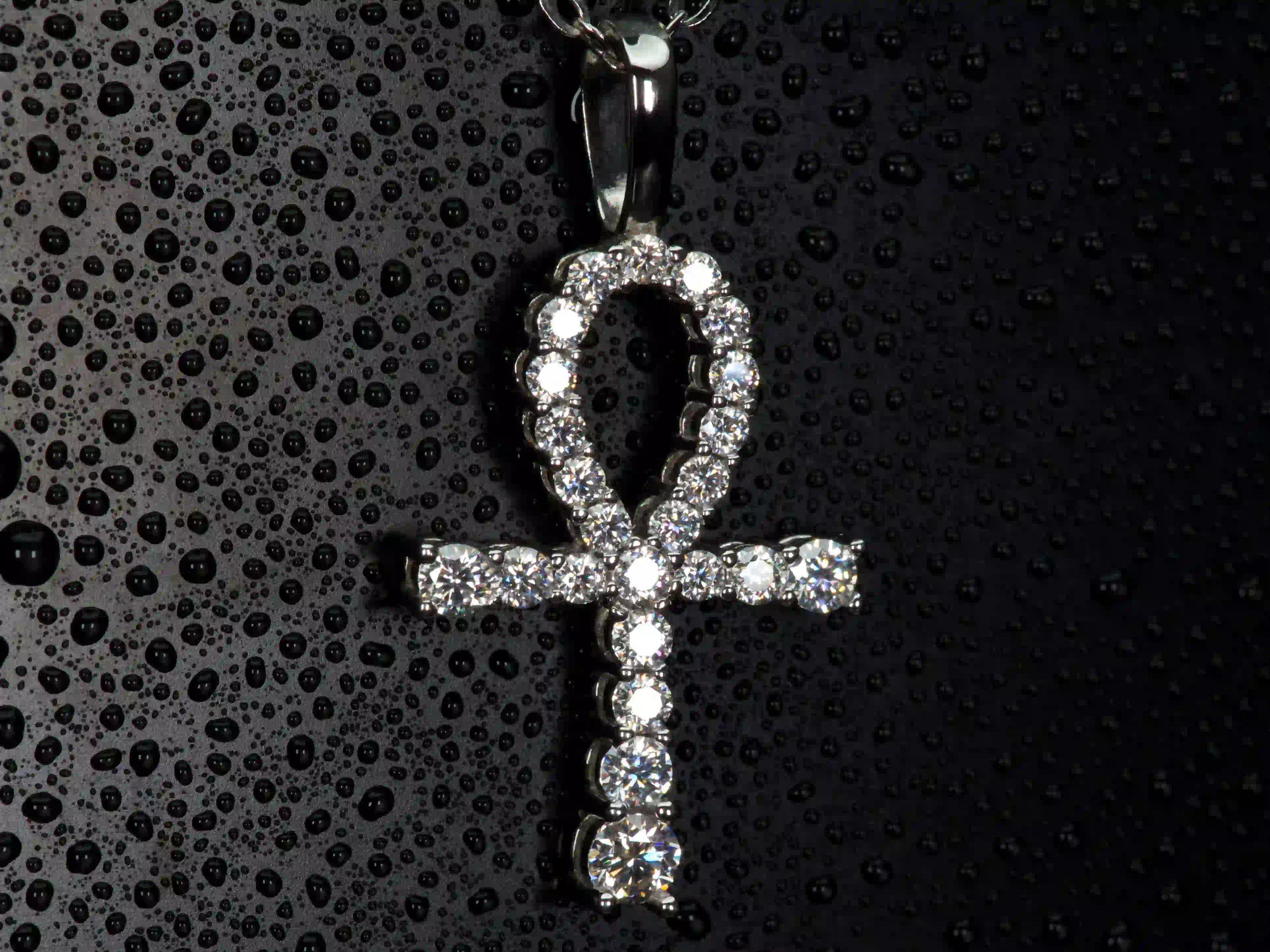 Echte Makroaufnahme einer Moissanite Ankh Kette in Seitenansicht – klare Form des ägyptischen Symbols mit intensiver Lichtreflexion der Steine aus 925 Silber