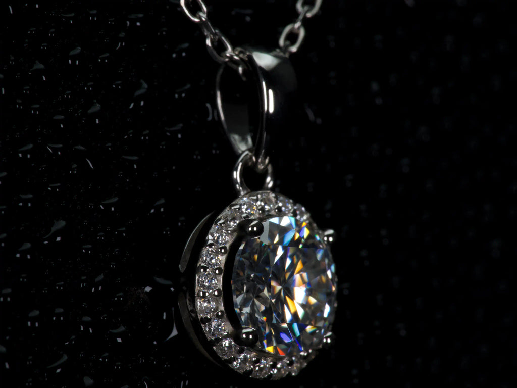 Seitliche Makroaufnahme der 1ct Halo Moissanite Kette aus 925 Silber & 18K Weißgold. Sichtbare Tiefe der Fassung mit echten Lichtreflexen und starkem Funkeln im echten Licht. Luxuriöser Halo Anhänger mit diamantähnlicher Härte für langlebigen Glanz.
