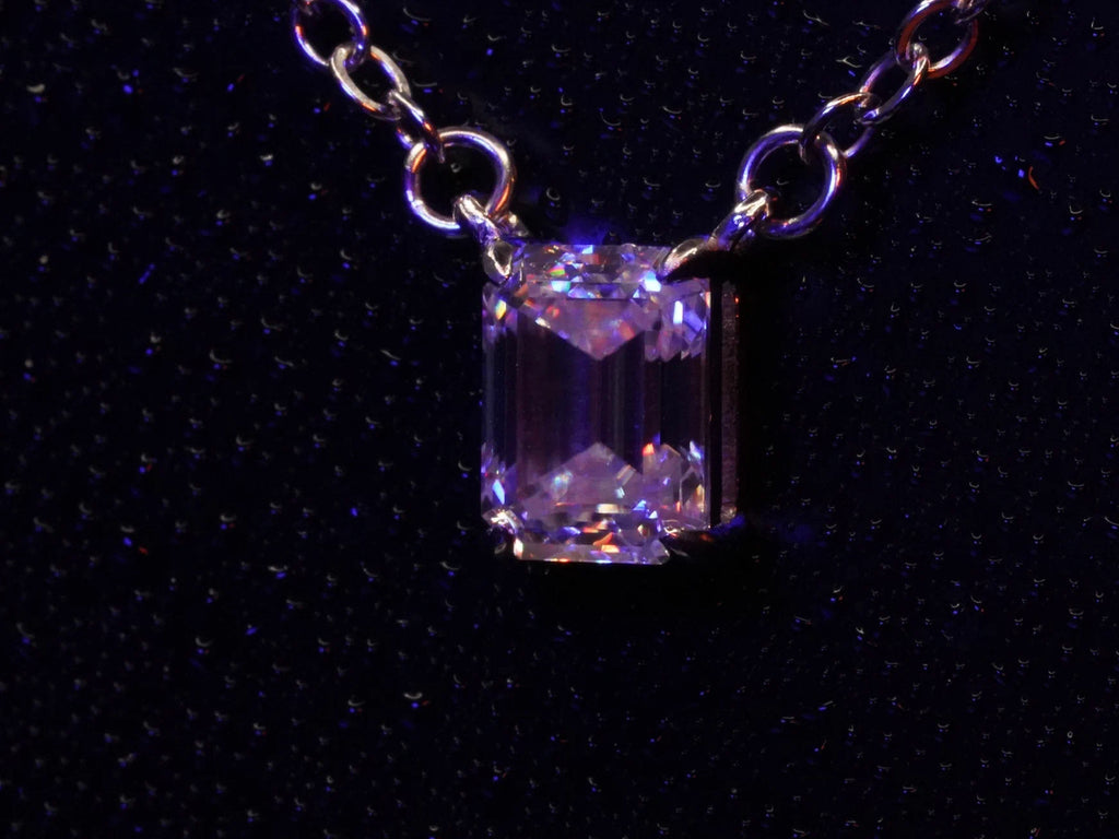 Seitliches Fotos vom Klar funkelnder Moissanite Smaragd Schliff Anhänger an der Silber Kette