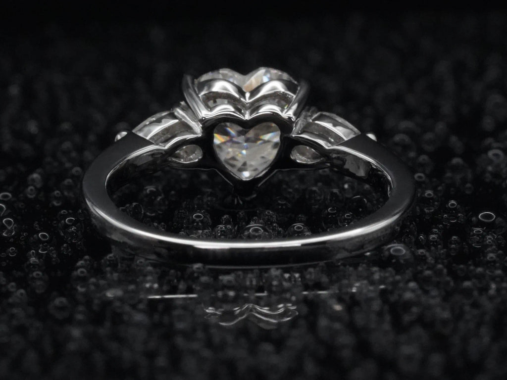 Rückseite eines Moissanite Rings mit Herz- und Tropfenschliff – offene Fassung verstärkt Lichtreflexion und sorgt für intensives Funkeln